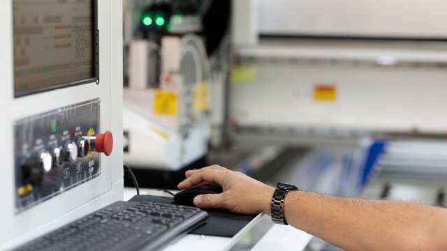 Hand styrer datormus vid maskinstyrning